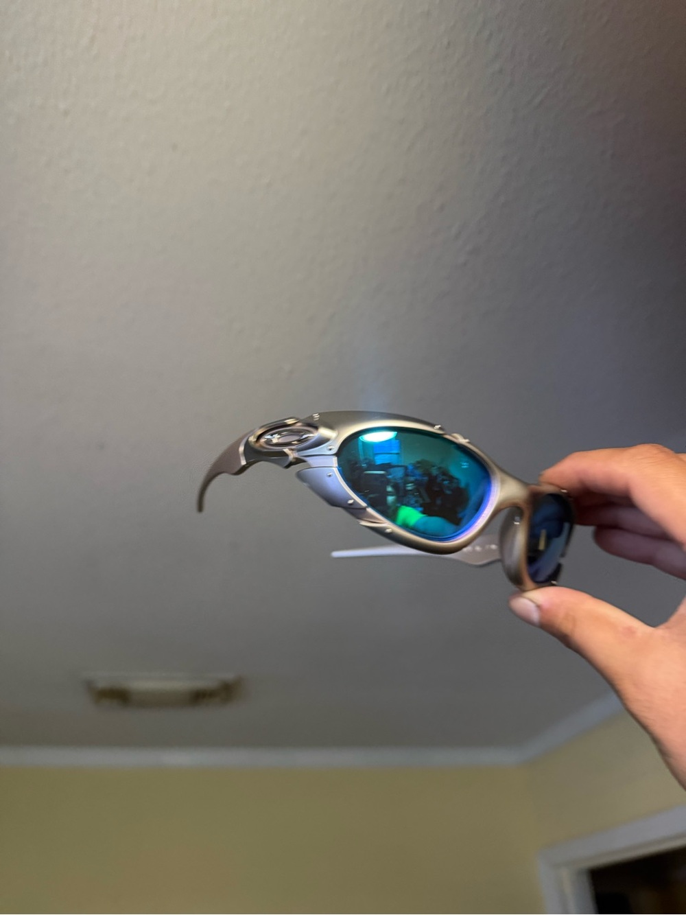 Oakley Silver Frame Sunglasses with Blue-Green Mirrored Lenses